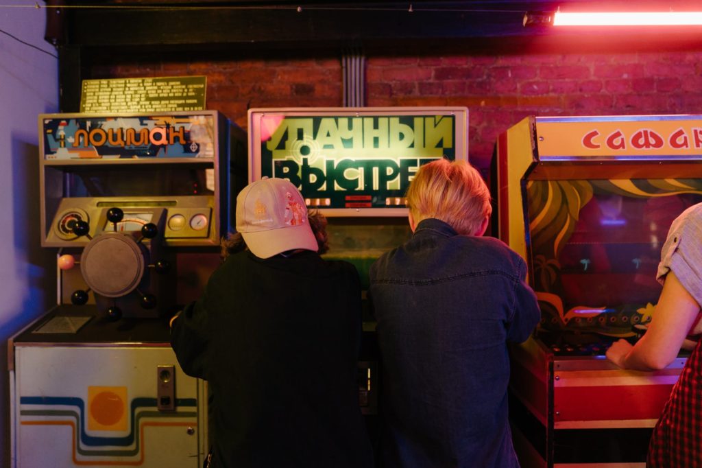 woman in black jacket standing in front of slot machine