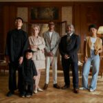 multiracial family posing together in luxury room