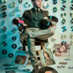 retro music enthusiast surrounded by vinyls