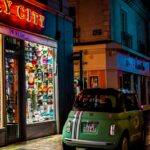 nighttime urban scene with colorful storefronts