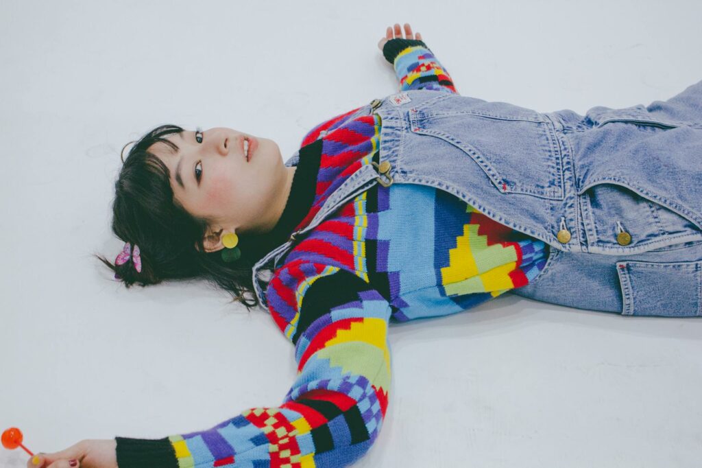girl with lollipop lying on floor in studio