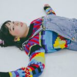 girl with lollipop lying on floor in studio