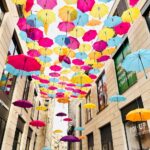 colorful umbrella art installation in city alley