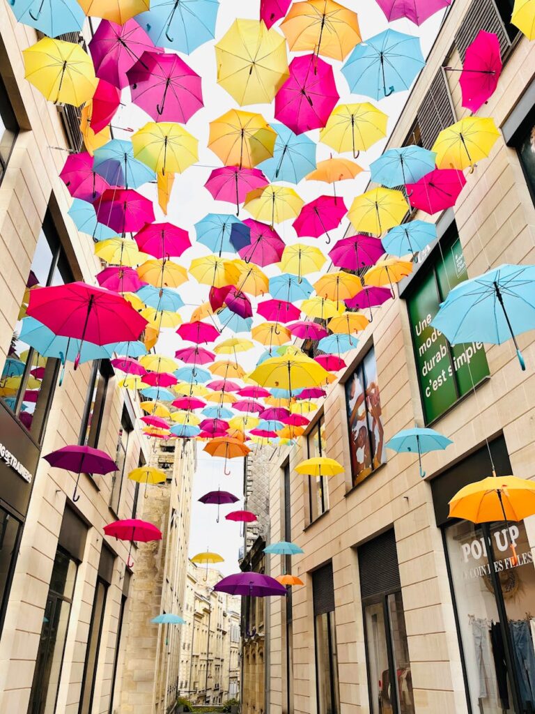 colorful umbrella art installation in city alley