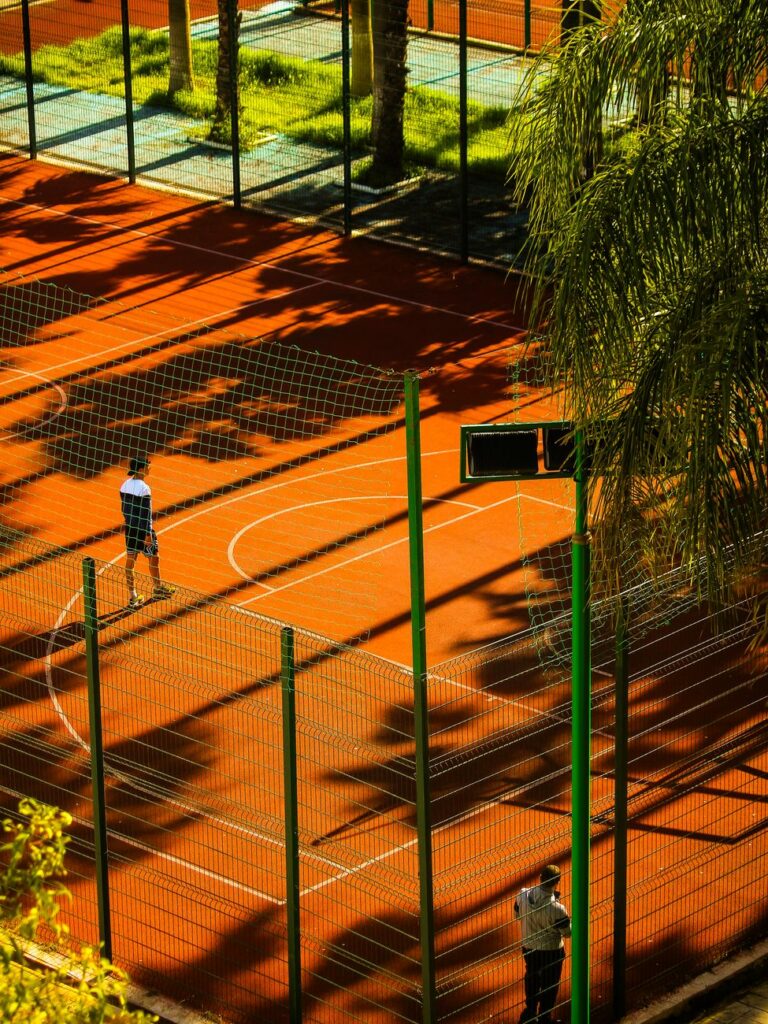 aerial view of outdoor basketball court in sunny setting